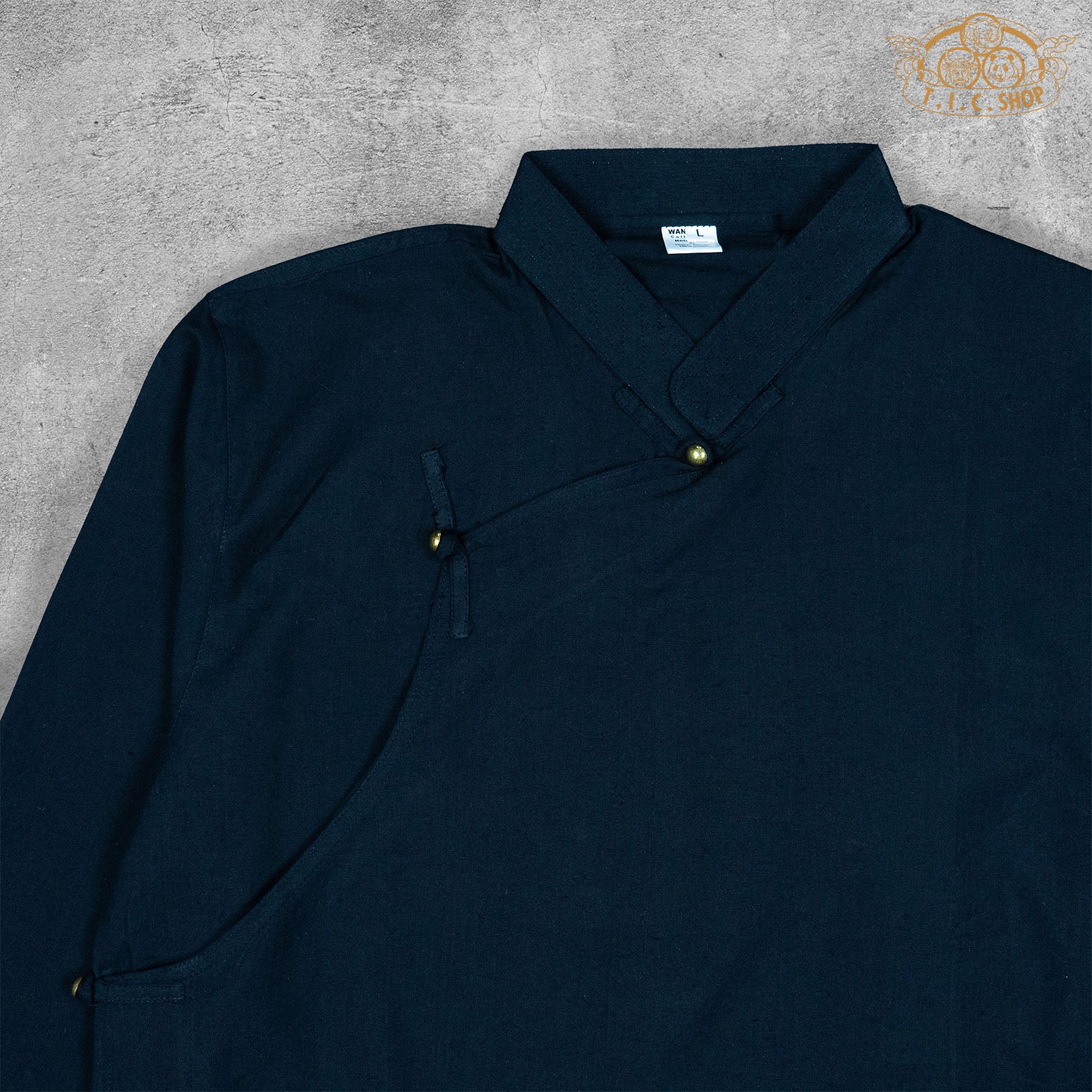 Close-up detail of the cotton fabric texture and stitching of the Tibetan-inspired shirt.