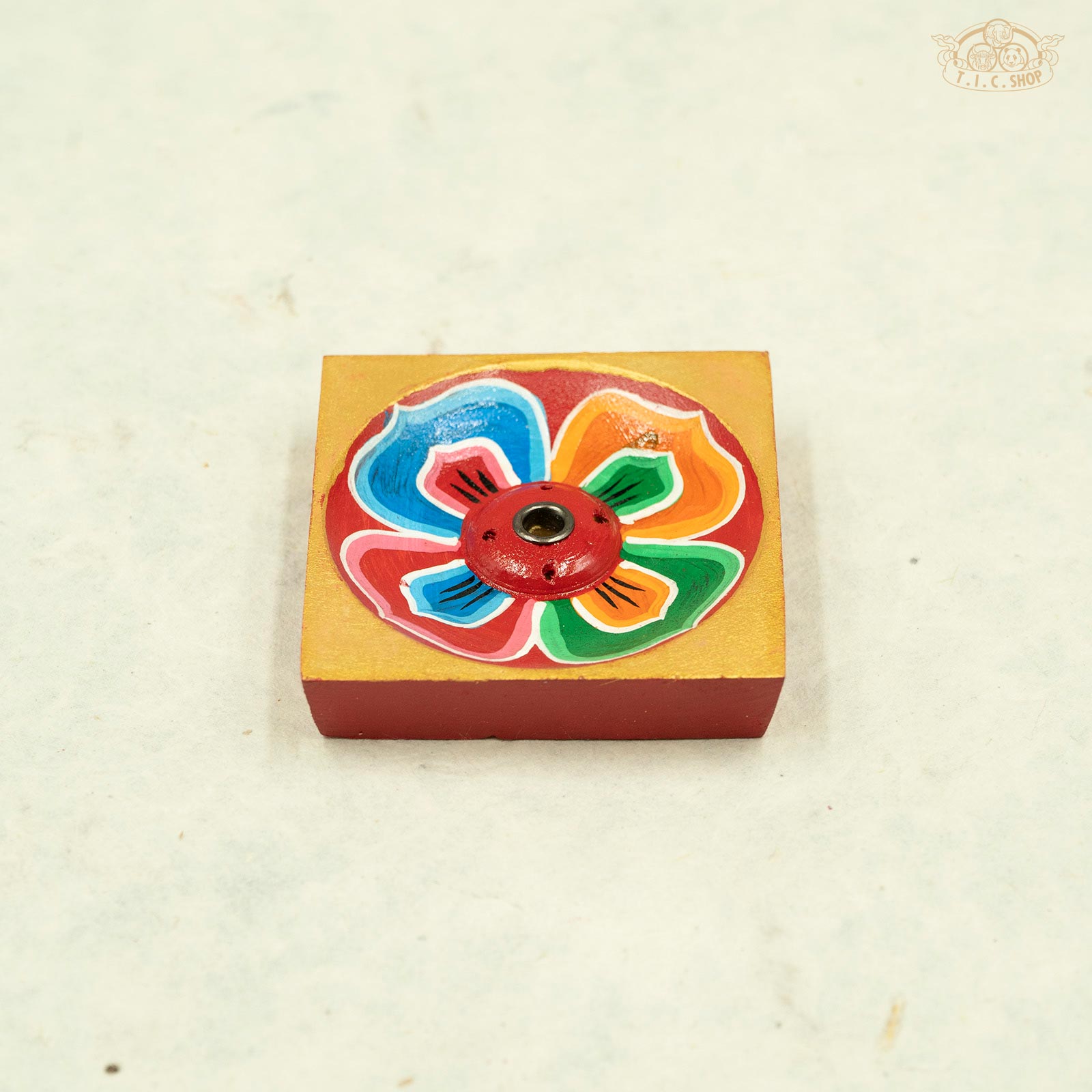 Front view of hand-painted Tibetan wooden incense holder with lotus flower design.