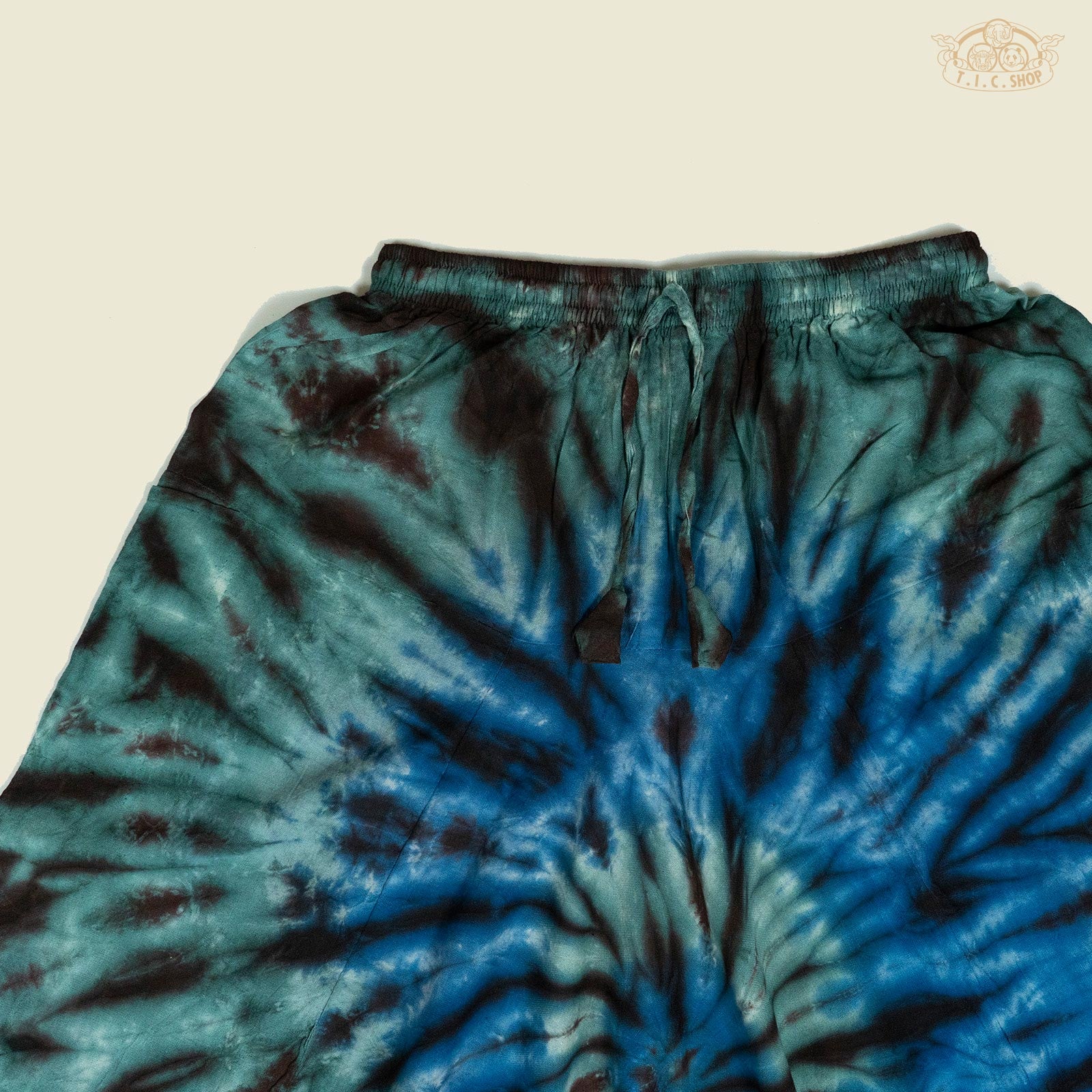 Detail of drawstring waist and elastic cuffs on tie-dye trousers.