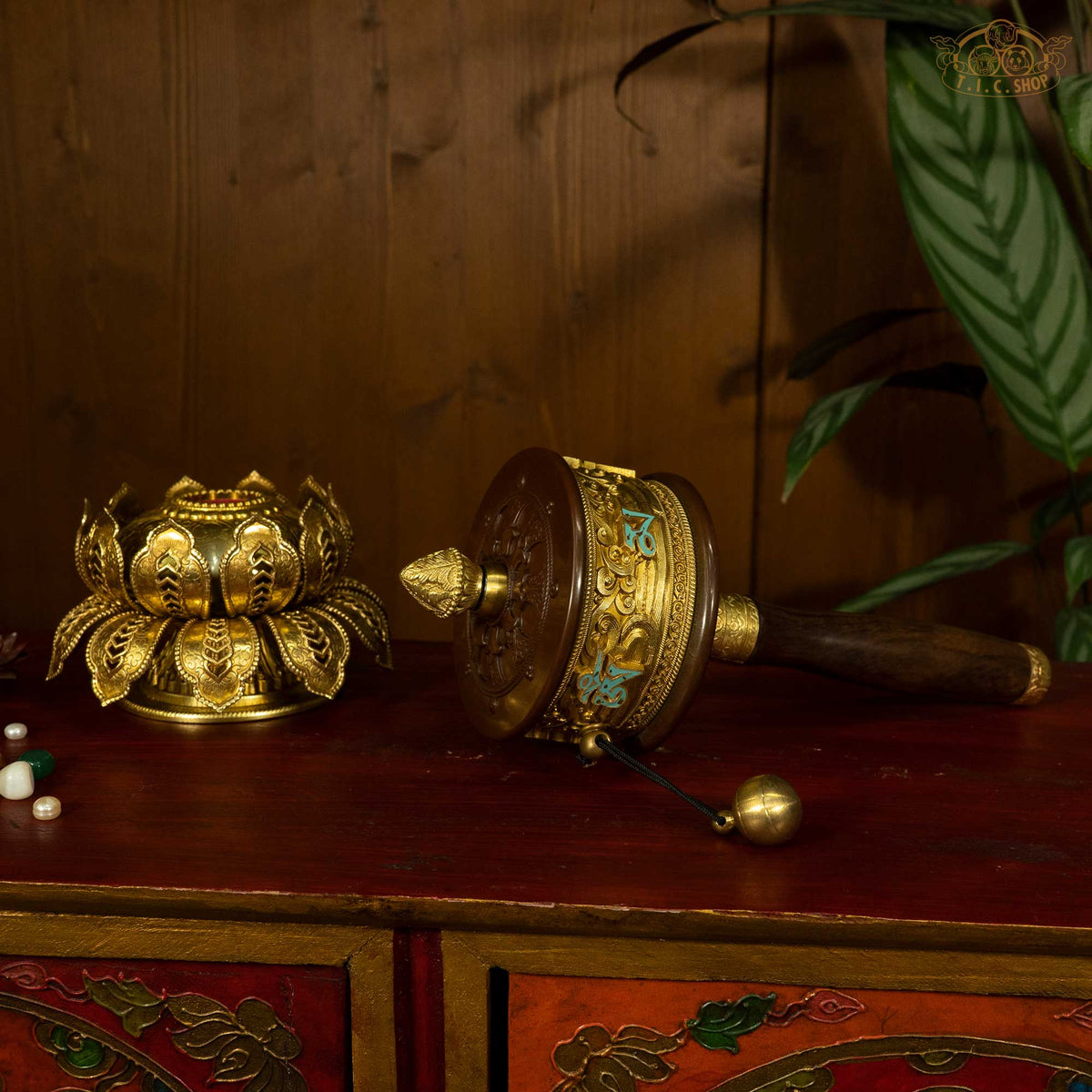 Top view of Tibetan prayer wheel showing carved lotus crest pin top