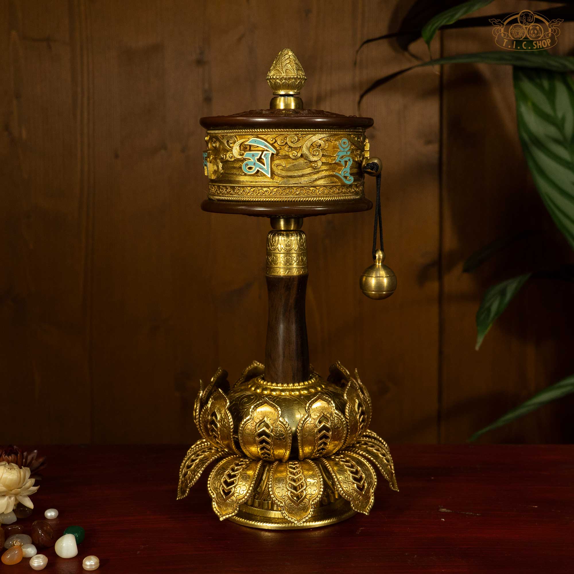 Tibetan hand prayer wheel with carved lotus stand full view