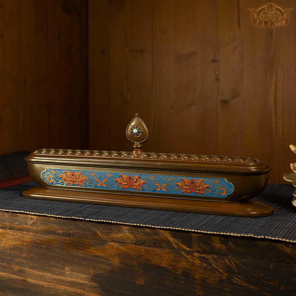 Side view of antique-style brass incense burner featuring detailed enamel inlay and patina finish.