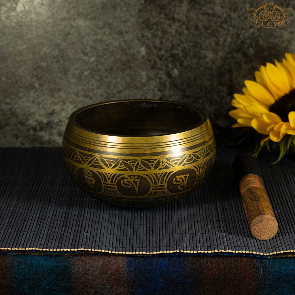 Side view of the brass Tibetan singing bowl, displaying its depth and shape.
