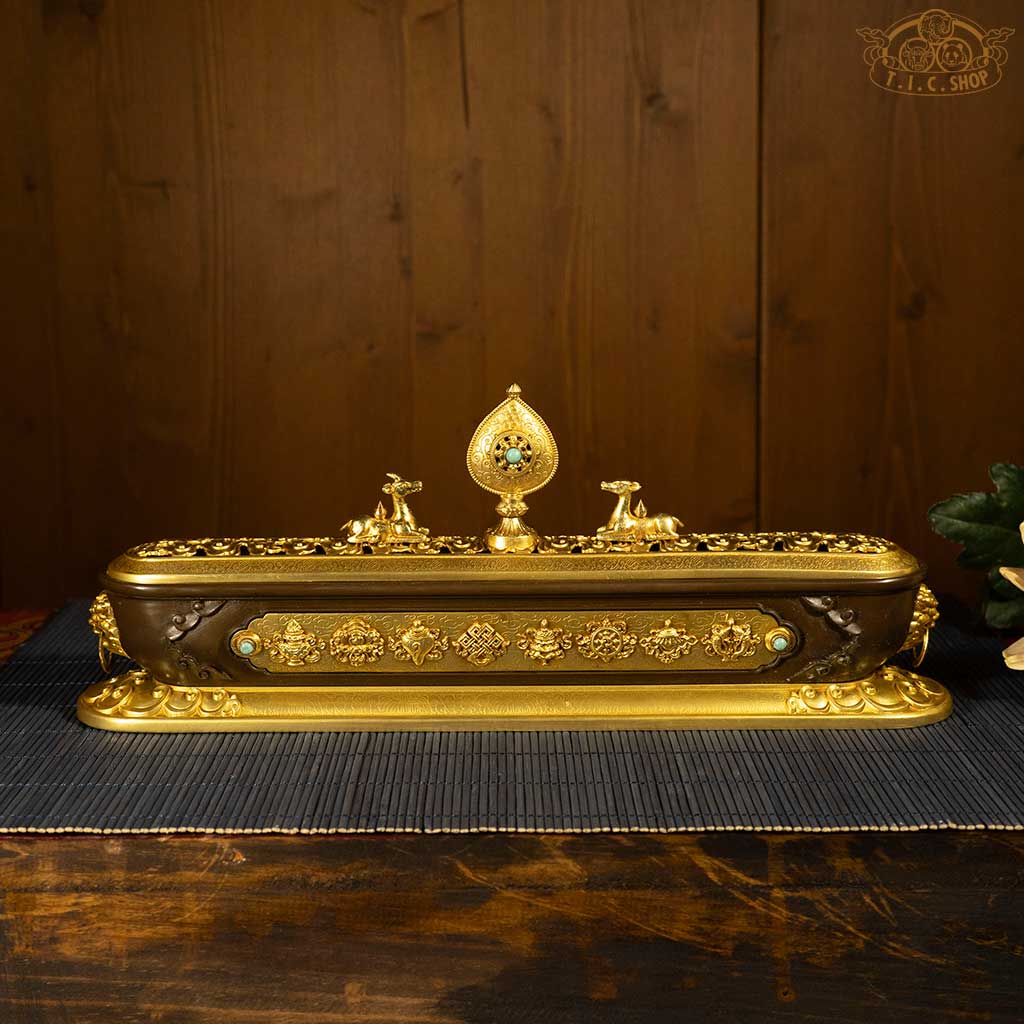 Front view of brass double deer dharma wheel incense burner featuring Eight Auspicious Symbols and openwork lid.