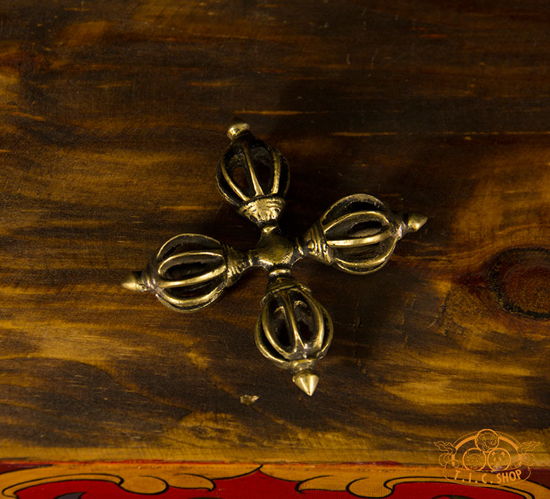 Close-up view of handcrafted brass Double Vajra showing detailed prongs and traditional Tibetan design