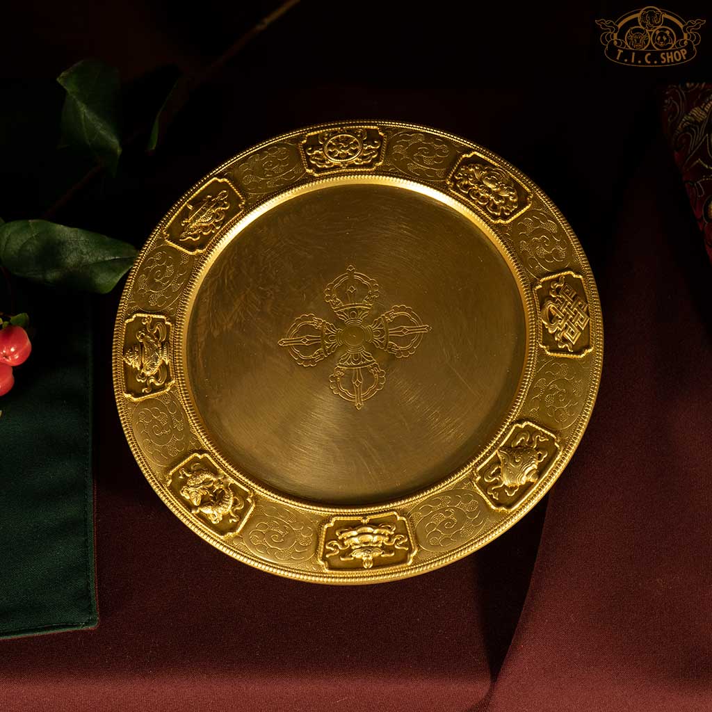 Mandala base plate engraved with the four major continents and eight sub-continents of Buddhist cosmology, for ritual offerings and meditation in Tibetan Vajrayana Buddhism.