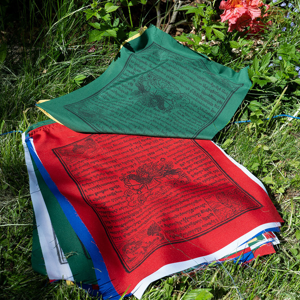 Detailed view of vibrant Tibetan Windhorse prayer flags made from cotton featuring traditional printed designs