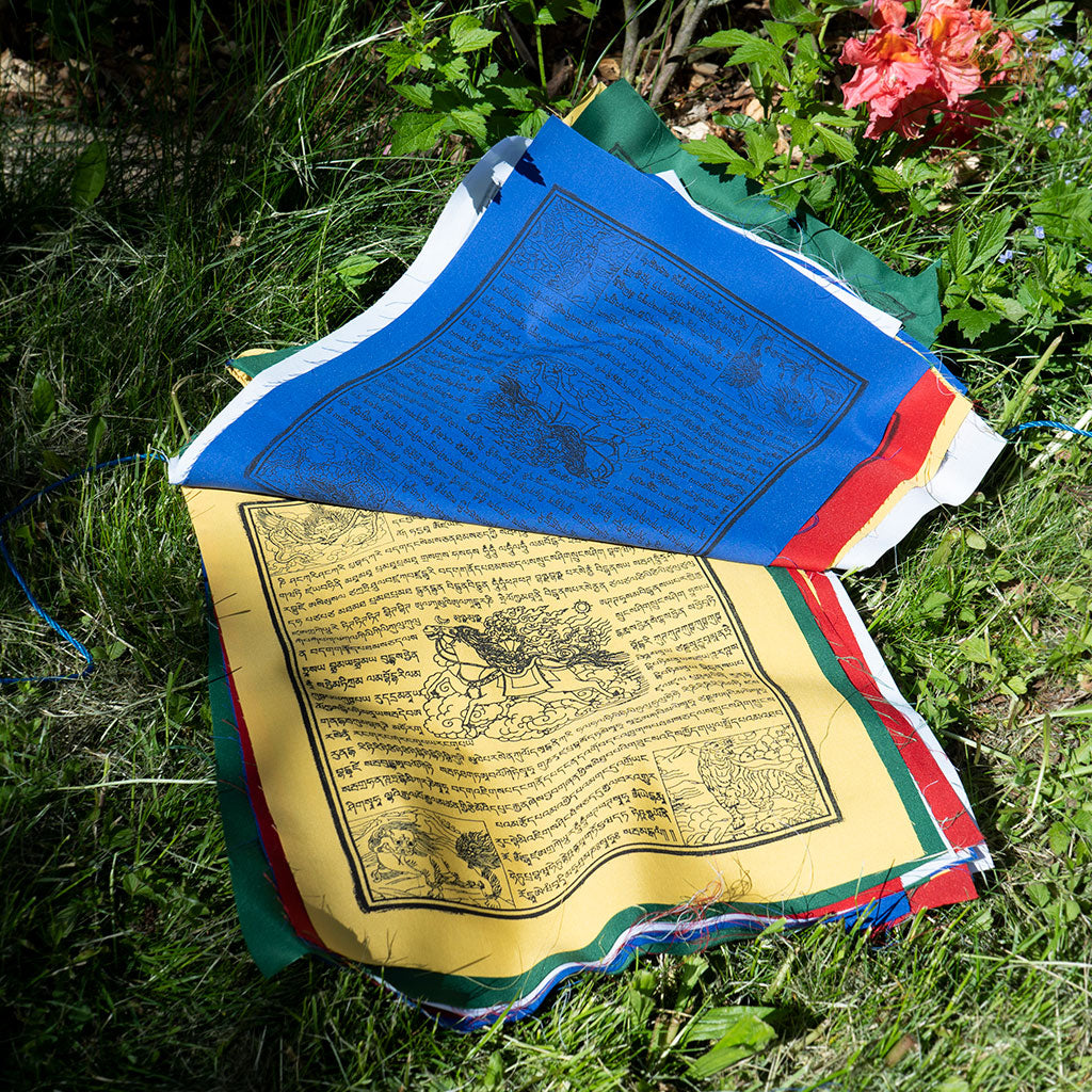 Close-up of colorful cotton Tibetan Windhorse prayer flag with traditional symbols for luck, protection, and harmony