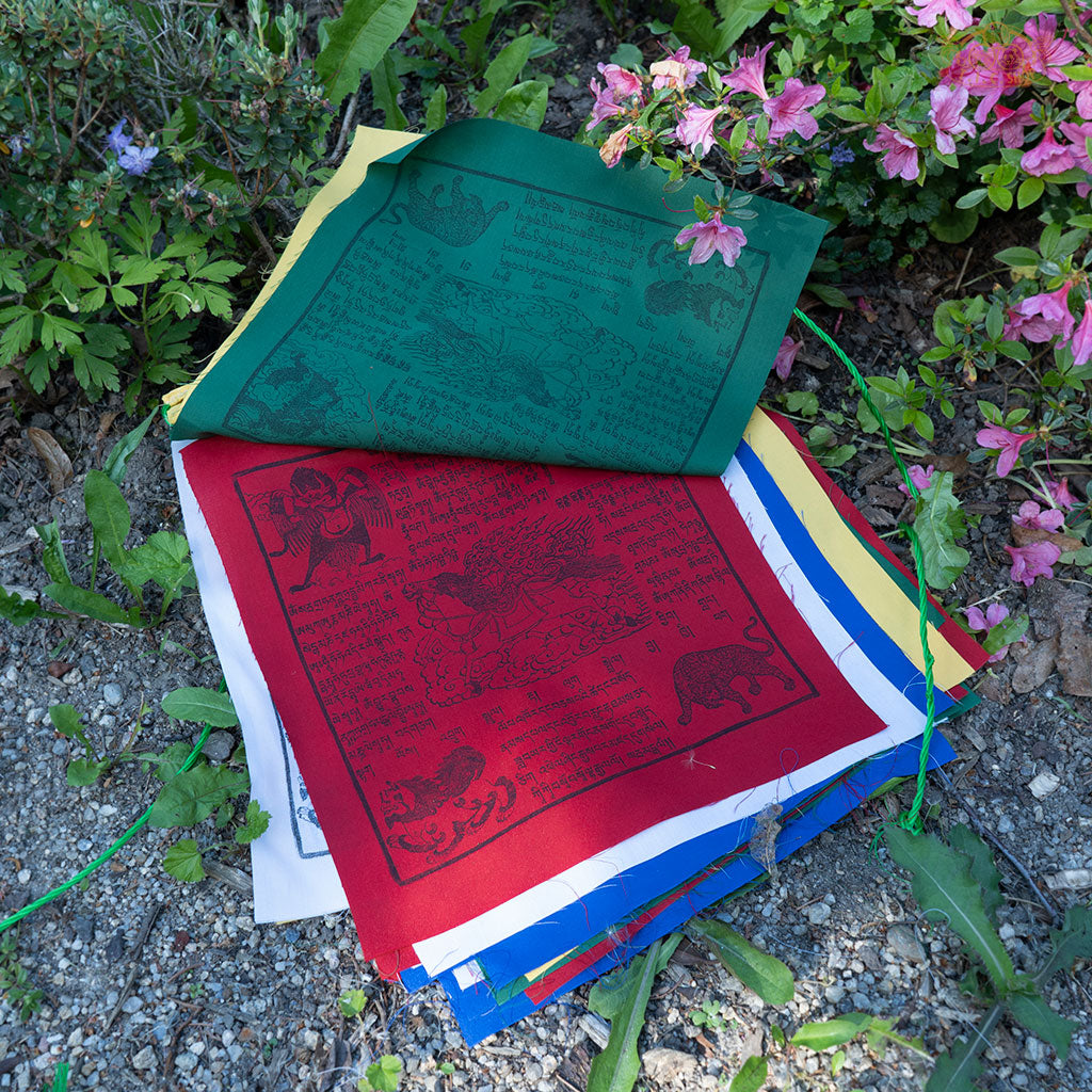 Close-up of colorful cotton Tibetan Windhorse prayer flag with traditional symbols for meditation and protection