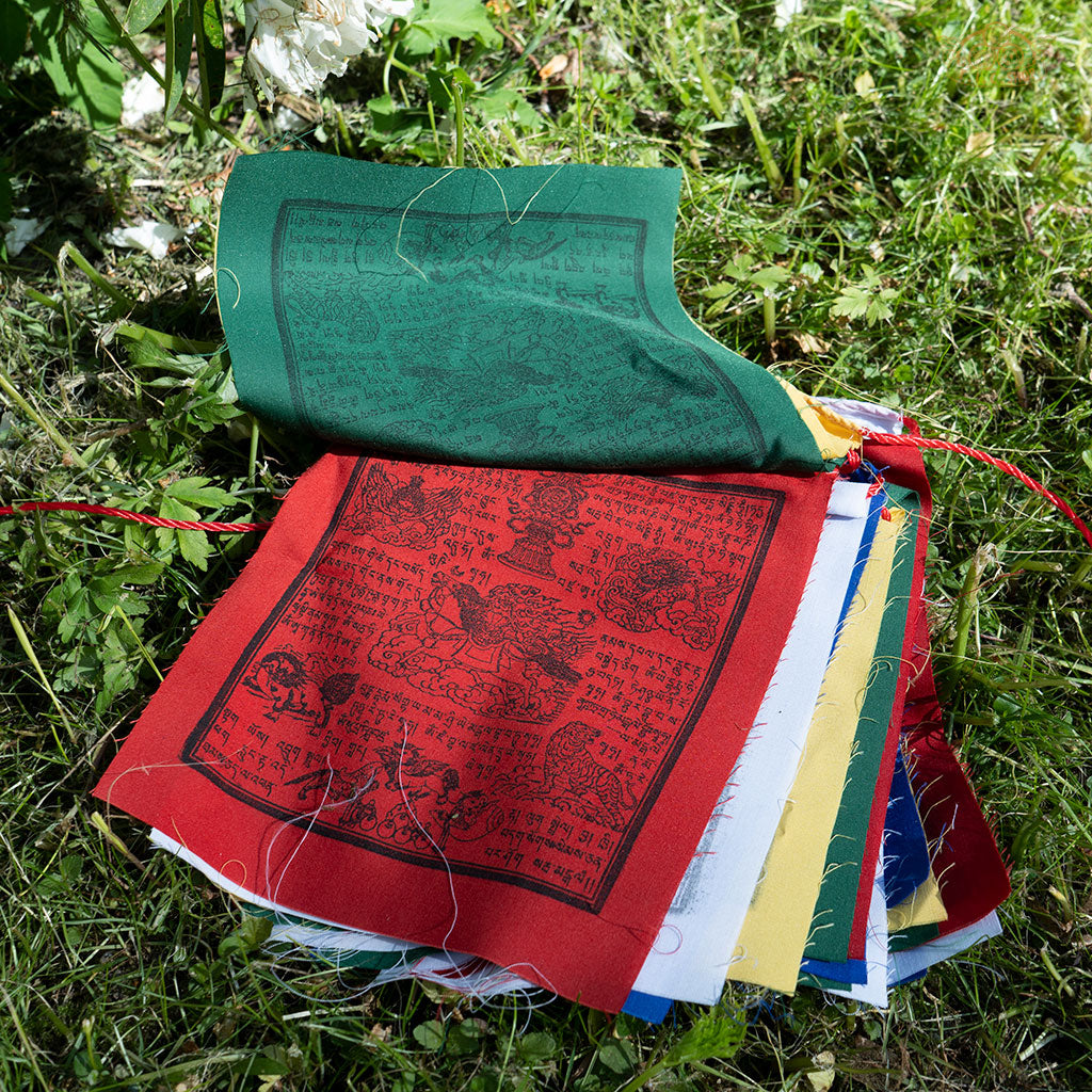 Close-up of colorful cotton Tibetan Windhorse prayer flag with traditional symbols for meditation and protection