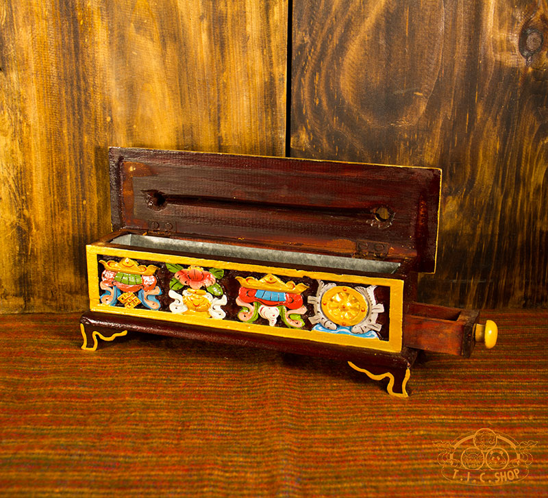 Side view of Tibetan incense burner box showing small drawer for storing incense and metal liner inside.

